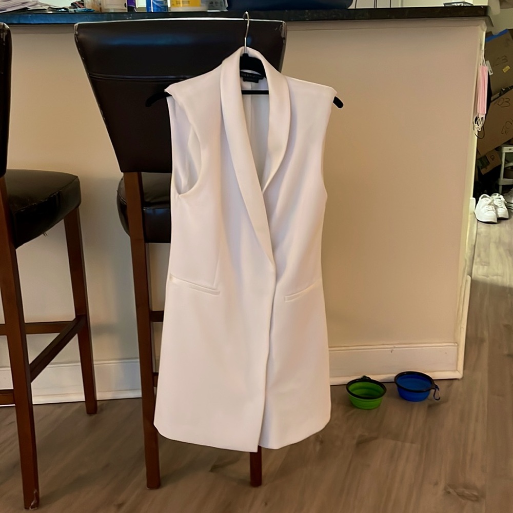 Worn once. Slight discoloration @ bottom/back of the dress, but very fixable.